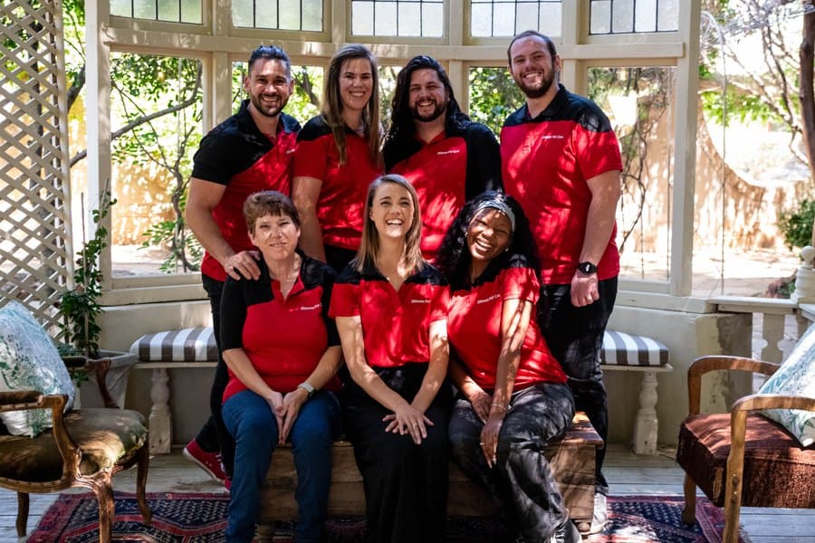 A team in matching shirts gathered for a group photograph