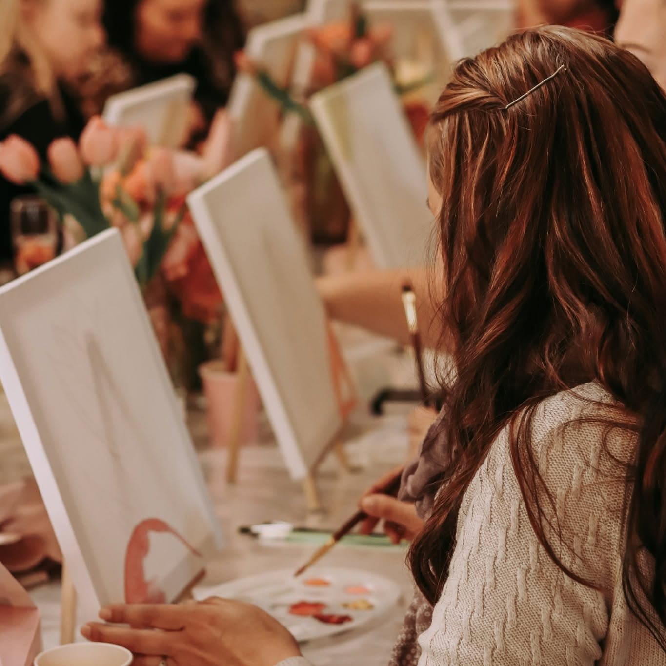 A guest painting at an easel during a craft session