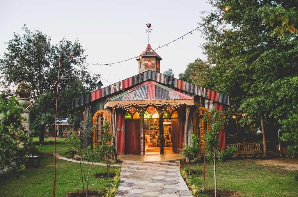 The pavilion at dusk, its arched doors open