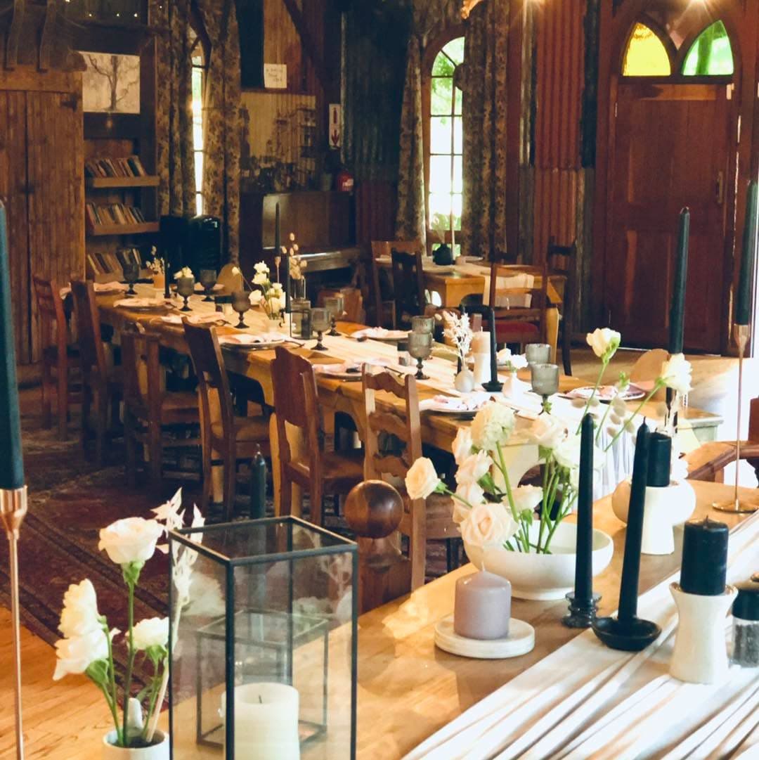 A long table laid with candles and roses